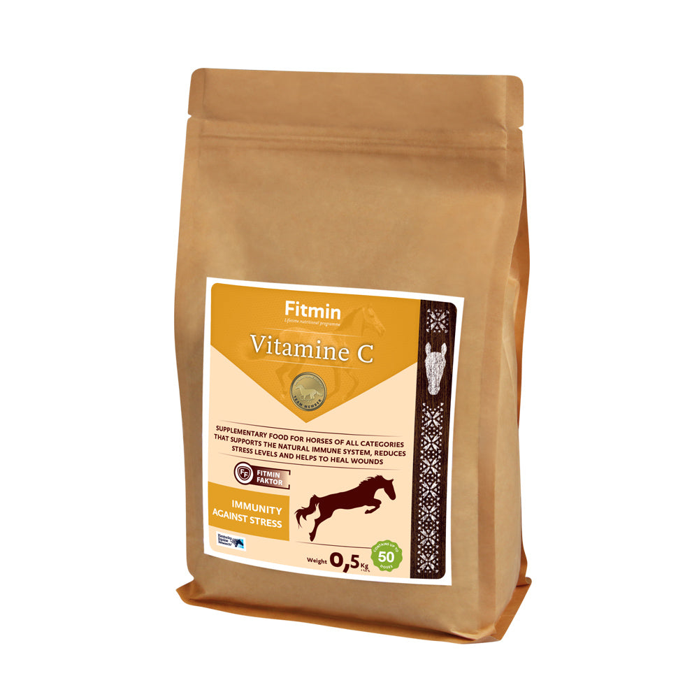 A 0.5kg paper bag of Fitmin Vitamin C supplementary food for horses. The label features an orange and cream design with a silhouette of a jumping horse, highlighting "Immunity Against Stress." It is designed to support the natural immune system, reduce stress levels, and assist in wound healing, containing up to 50 doses.