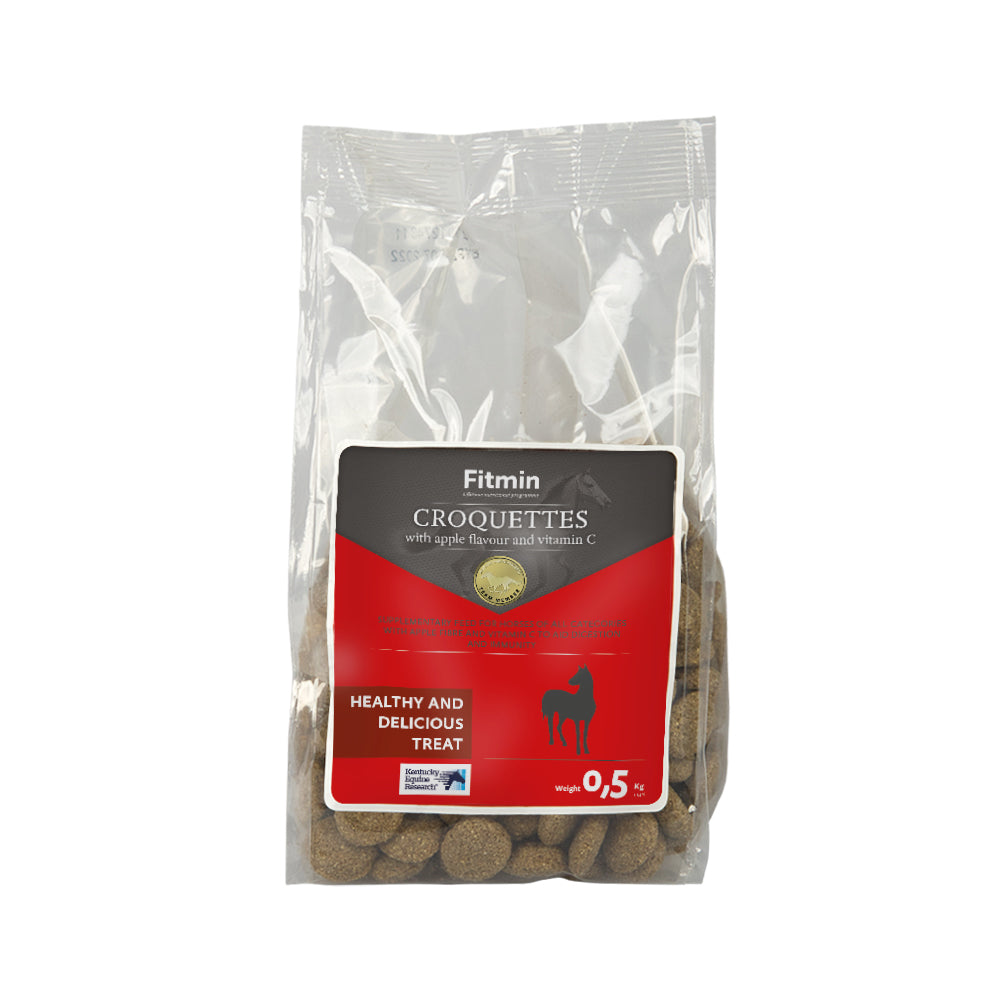 A 0.5kg clear plastic bag of Fitmin Horse Croquettes. The red and black label indicates these are apple-flavoured treats enriched with Vitamin C and apple fibre to support digestion and immunity for horses of all categories.
